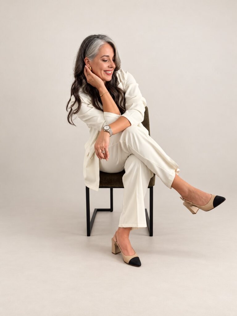 Dina Besirevic, founder of ELARIS North Shore, seated in a white suit